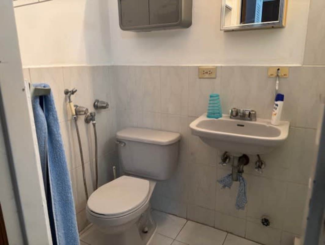 Compact bathroom with walk-in shower and tile walls PH La Cresta Panama