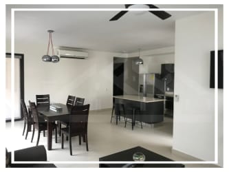 Kitchen with stainless steel appliances open to dining room in PH Mosaic Panama Pacifico