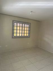 Empty tiled room with window security bars neutral colors Green Village Panama
