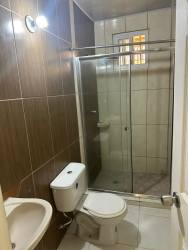 Small bathroom with glass shower enclosure and toilet fixtures Green Village Nuevo Arraiján
