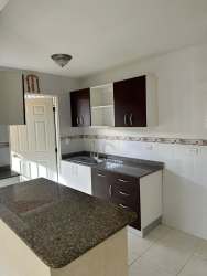 Compact modern kitchen with granite top cabinets tiled floor in Green Village Nuevo Arraiján Panama