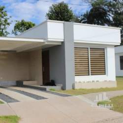 One-story house with white facade and fenced yard at Residencial El Espino Santiago Panama
