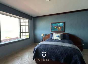 Bathroom with glass shower, decorative tile walls, green counter, wood vanity in Costa Esmeralda beachfront home