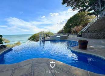 Colorful bathroom with tiled countertop, glass shower enclosure and large mirror in beachfront Coronado villa Panama