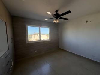 Bedroom with tiled floor ceiling fan large window modern finish in New West Costa Verde