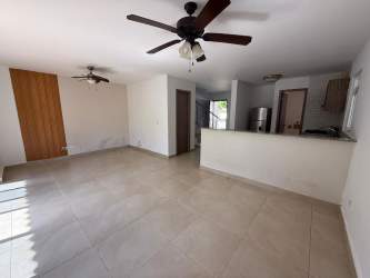 Bright spacious living room open kitchen with tile floors ceiling fans Costa Verde New West Panama