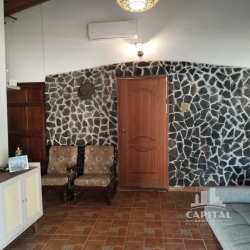 Bedroom at Santa Ana farm estate with two windows, blue bedding, ceiling fan, natural light in Los Santos Panama