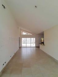 Bright tiled-floor living space with sliding doors in Playa Dorada Panama house