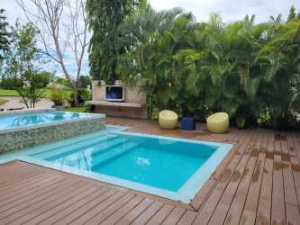 Spacious outdoor covered terrace with lounge seating and pool view at Bijao Miraflores Villa for sale