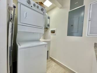 Laundry with stacked washer dryer and storage in beachfront Punta Chame condo Panama