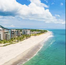 Modern kitchen with granite countertops stainless appliances open to living room PH Playa Caracol Punta Chame