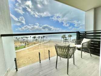Bright living area with sliding glass doors to balcony ocean view PH Playa Caracol beach condo Panama