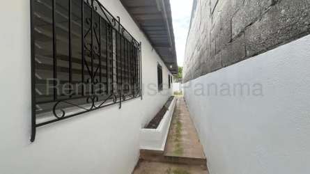 Bedroom with ceramic tile floors and barred windows in Panama house for sale
