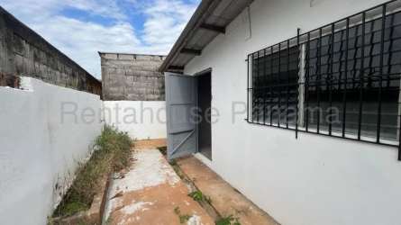 Galley kitchen with red and white cabinetry tile backsplash Panama house