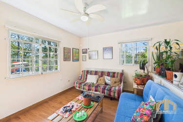 Open kitchen with natural light, wood cabinets and breakfast bar in Potrerillos Abajo Dolega Panama