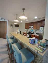 Granite kitchen with breakfast bar and pendant lights in CasaMar Resort beach apartment Panama