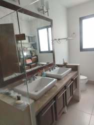 Modern master bathroom with double sink vanity and glass shower CasaMar Resort Panama