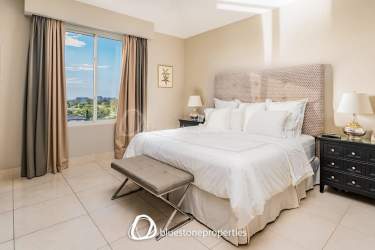 Primary bedroom with large windows opening to terrace and stunning lake views Buenaventura Panama