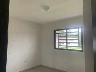 Living room open layout with sliding door overlooking yard in Residencial Bariloche Dolega Chiriquí rental house