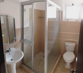 Modern bathroom with glass enclosure, pedestal sink, tiled finish near Vista Alegre Panama Oeste