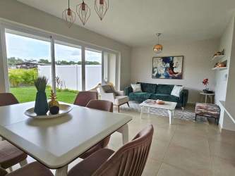 Covered carport with landscaped entrance two-story house New West Costa Verde Panama