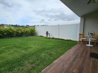 Private lawn and garden area with white fencing New West Costa Verde Panama