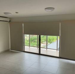 Open living and dining room with balcony access at Panama Pacifico Woodlands PH Midrise
