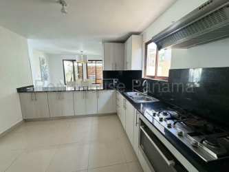Modern minimalist living area with ceiling fan and egg swing chair in Senderos de Bambú Arraiján