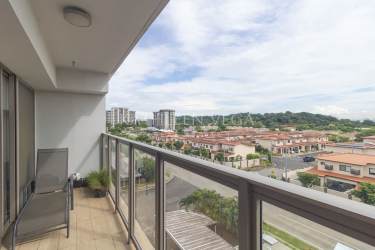 Balcony with glass railing overlooking green areas in Woodlands Panama Pacifico