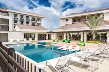 Luxury apartment complex with pool, sun loungers, shaded pergolas in Panama Pacifico