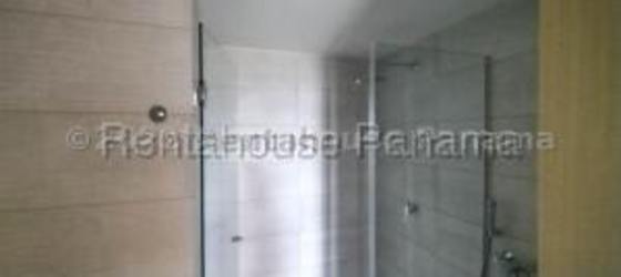 Modern kitchen with appliances, wood cabinetry and pendant lights Mosaic Panama Pacifico