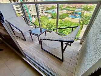 Contemporary kitchen with wood cabinets, stainless appliances in Panama Pacifico rental apartment