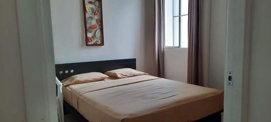 Minimalist bedroom with full bed wall art window Playa Dorada Panama