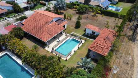 Bedroom with twin beds, ceiling fan, tile floors coastal decor in luxury Punta Barco estate