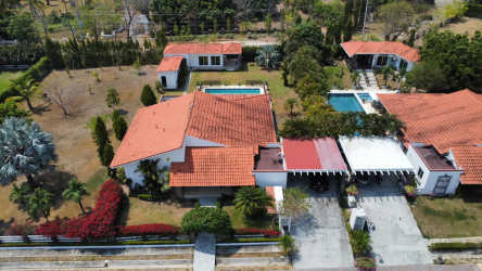 Drone view estate compound Mediterranean roofs guest house private pool lush gardens Punta Barco Panama