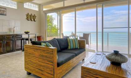 Living room with glass doors opening to oceanview balcony Casa Caracol Panama