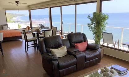 Bedroom with sliding glass doors to oceanview balcony in Playa Corona beachfront villa Panama