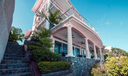 Mediterranean villa with balconies stone accents landscaped garden Casa Caracol Panama