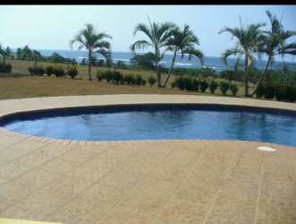 Lush tropical gardens and open green spaces at Pedasi beachfront ranch for sale