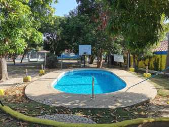 Rustic kitchen with wood cabinets, gas stove, refrigerator, microwave in Coronado Nueva Gorgona