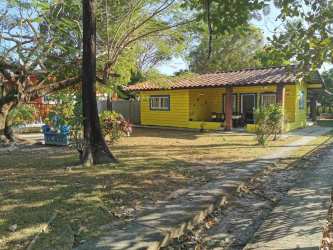 Private swimming pool with covered bohio gazebo beside tropical garden at beach house in Coronado Panama