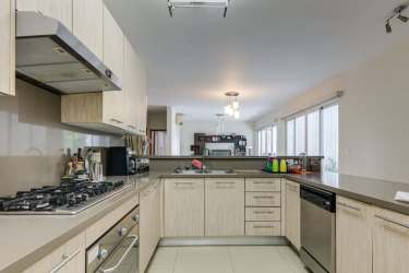 Contemporary kitchen with stainless appliances and breakfast bar at Bijao Beach Club condo Panama