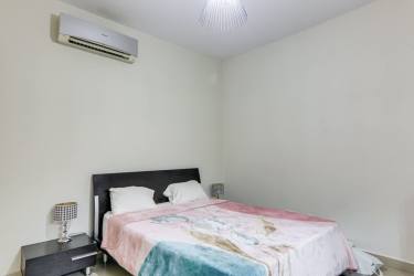 Spacious master suite with garden-facing windows in Bijao Beach residence Panama