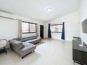 Living room with sectional sofa, large windows, tile flooring in PH Summer Hills Costa Verde Panama