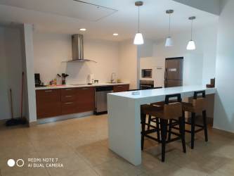 Beachfront lagoon pool and palm trees at Nikki Residences Playa Blanca Panama