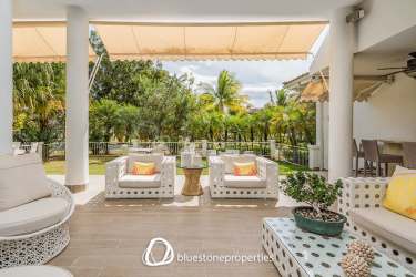 Spacious covered patio with garden views and sitting area at Bijao beach resort condo Panama