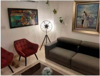 Spacious bedroom with queen bed, AC, and panoramic window in Veracruz Panama apartment