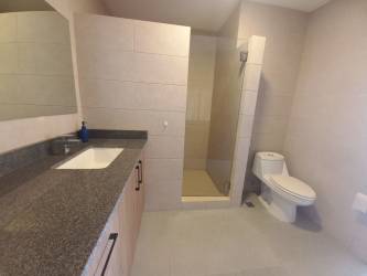Modern bathroom with tile walls, vanity and walk-in shower, Costa Verde apartment