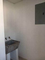Concrete utility sink laundry space in affordable Ventanas al Mar La Chorrera Panama house