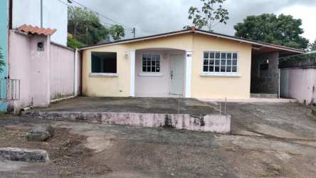Single-story house with yellow exterior, porch and driveway in Villas de La Alameda Arraiján Panama